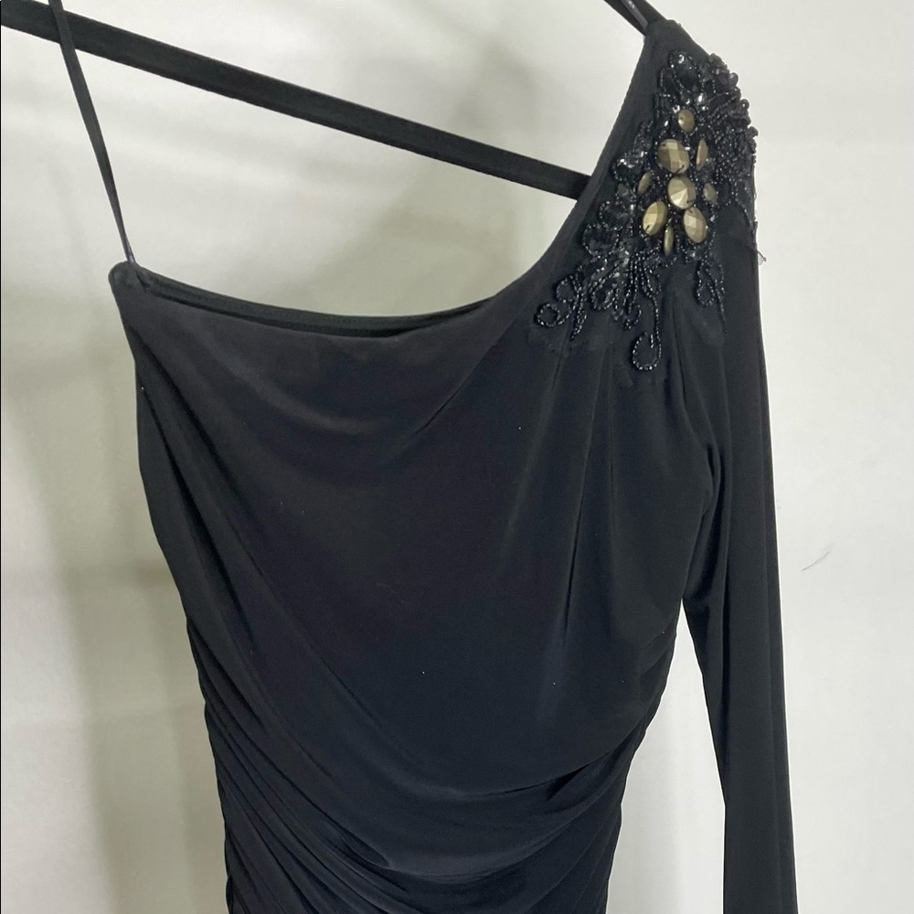 Black ruched cocktail dress with gold detail at shoulder